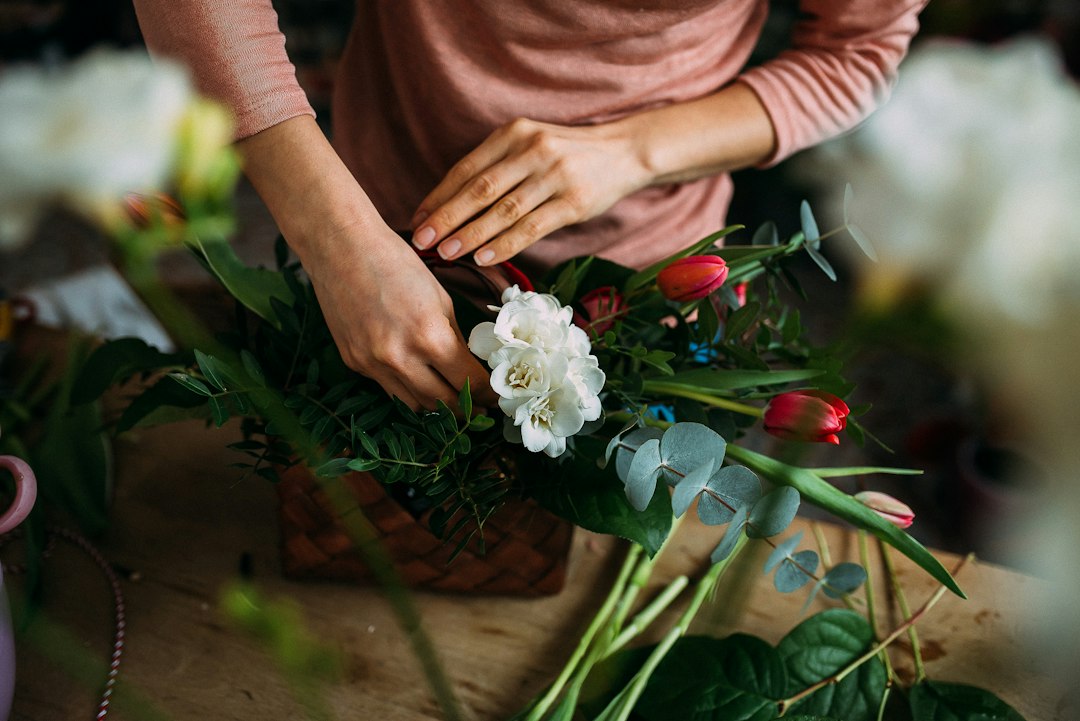Florist arranging colorful fresh flowers